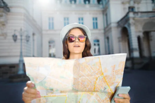 Young woman with a map travelling Europe